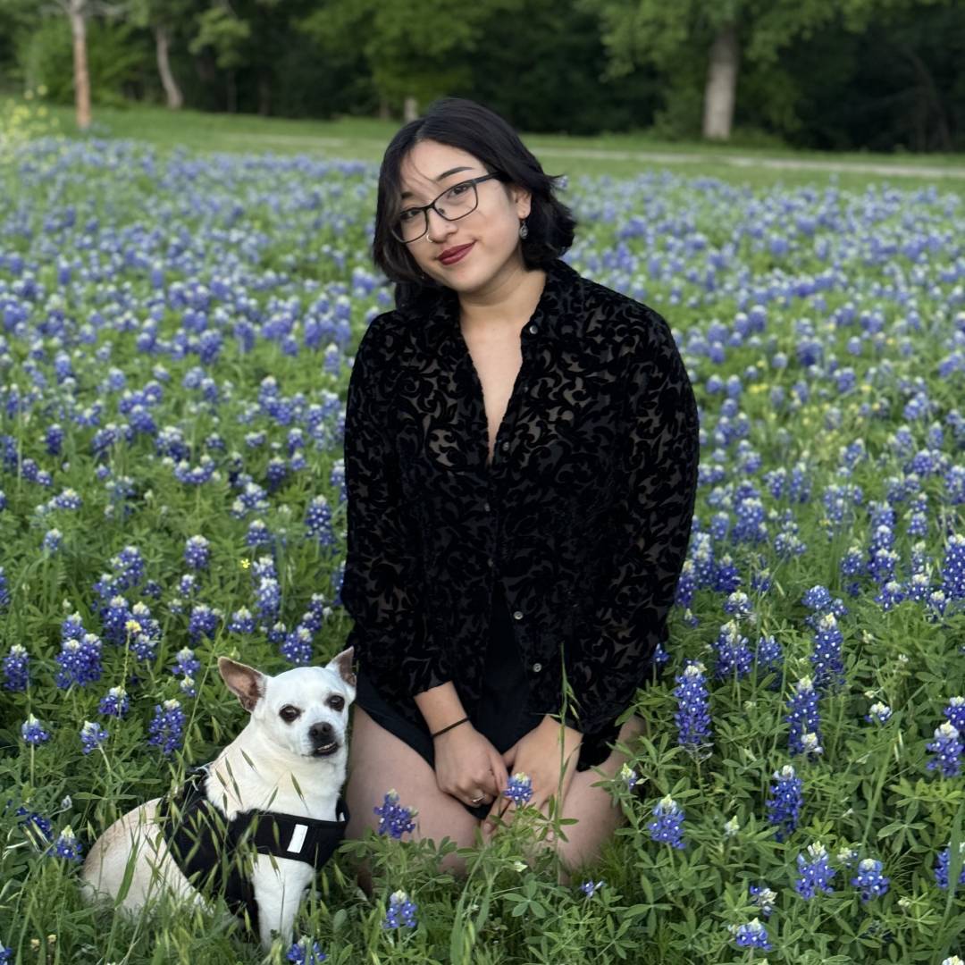 girl sitting with pet in the flower garden